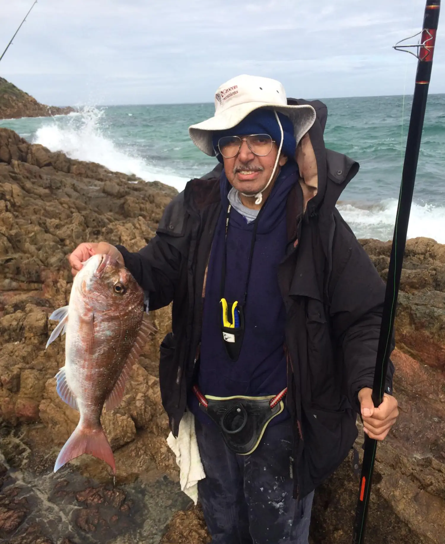 a man holding a snapper by its gill